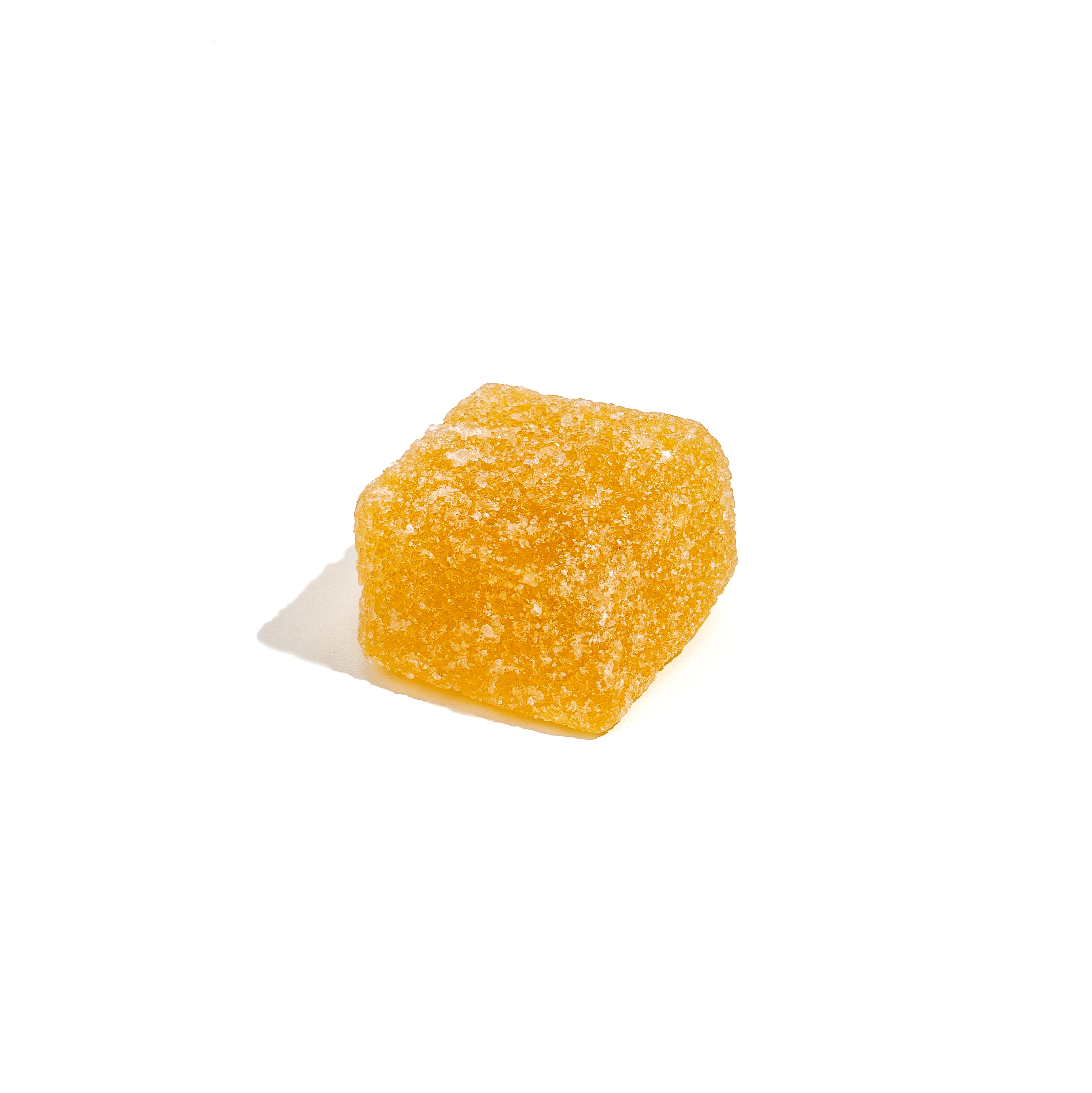 Yellow CBD gummy cube with sugar coating on white background, showcasing sample size for wellness exploration by Honey Bloom.