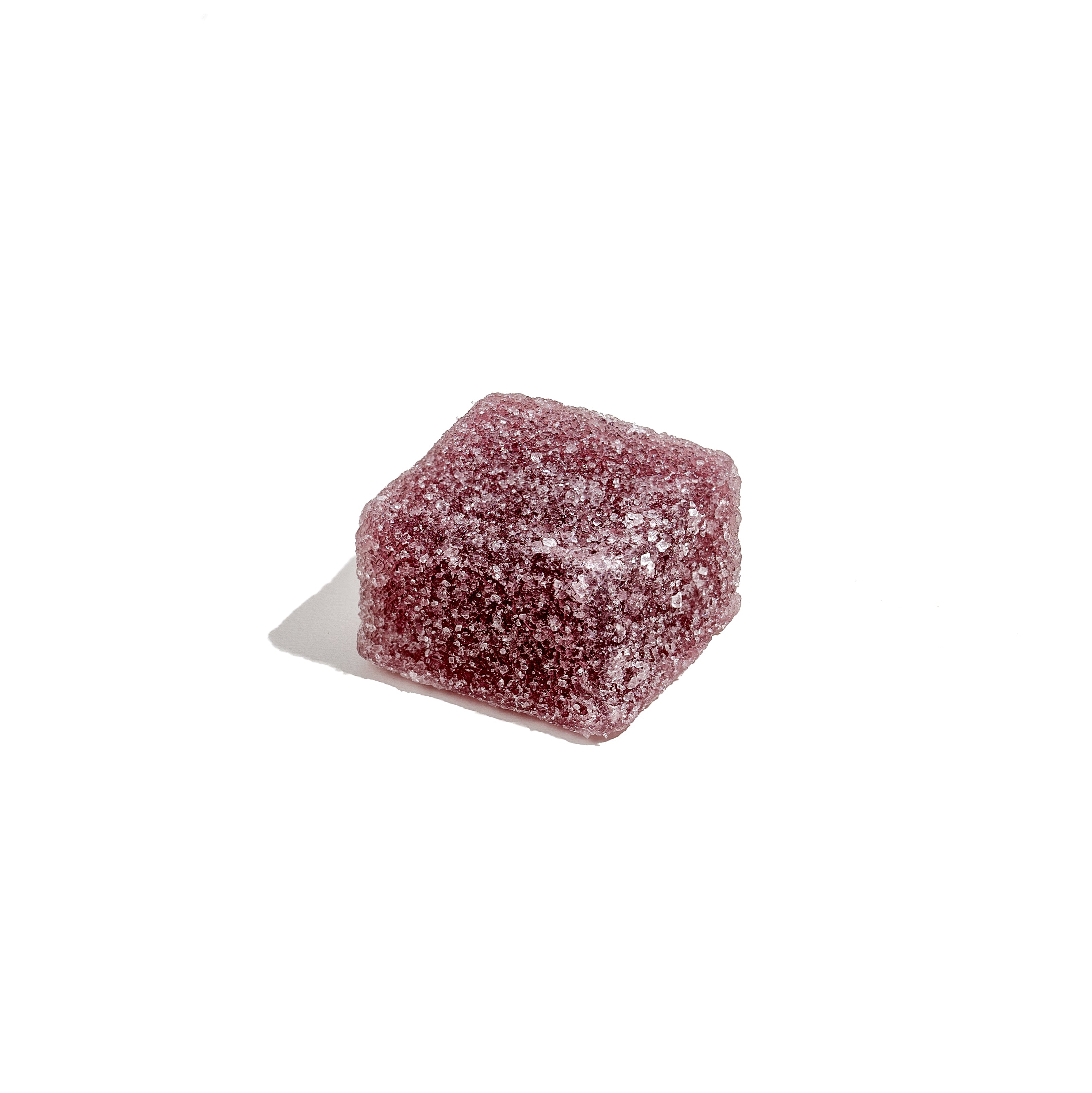 Close-up of a single, sugar-coated, purple CBD gummy cube from Honey Bloom, ideal for wellness exploration.